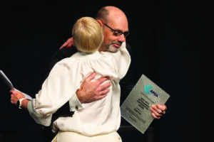 Peter Cox receives his award for outstanding contribution from APGA President Donna McDowell.